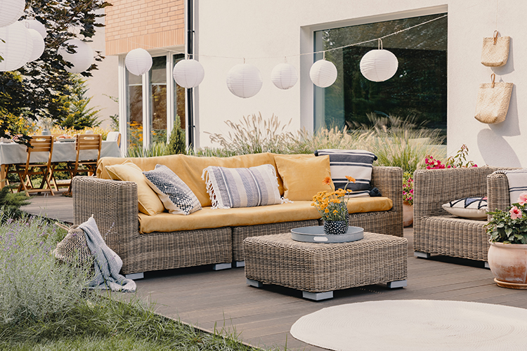 Outdoor Patio space with rattan furniture, completed by patio contractor, Standing Lites.